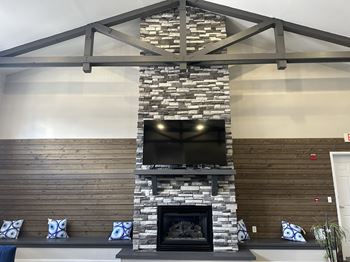 a living room with a fireplace and a tv